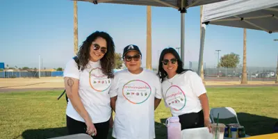 women standing behind a table